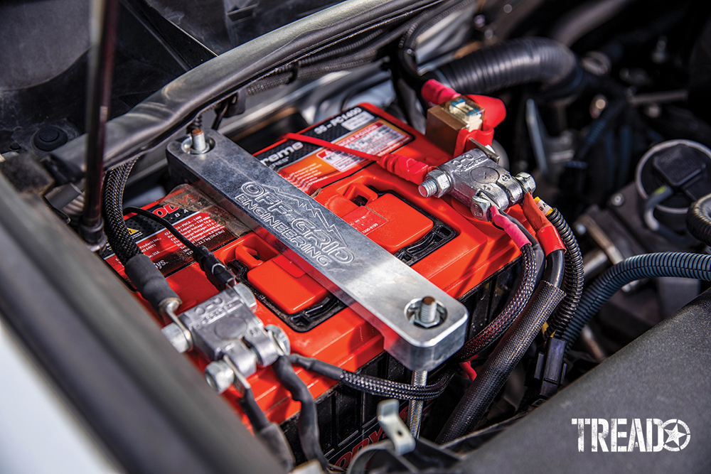 Off-Grid Engineering dual battery kit and Odyssey battery with red top is securely mounted in the 4Runner's engine bay.