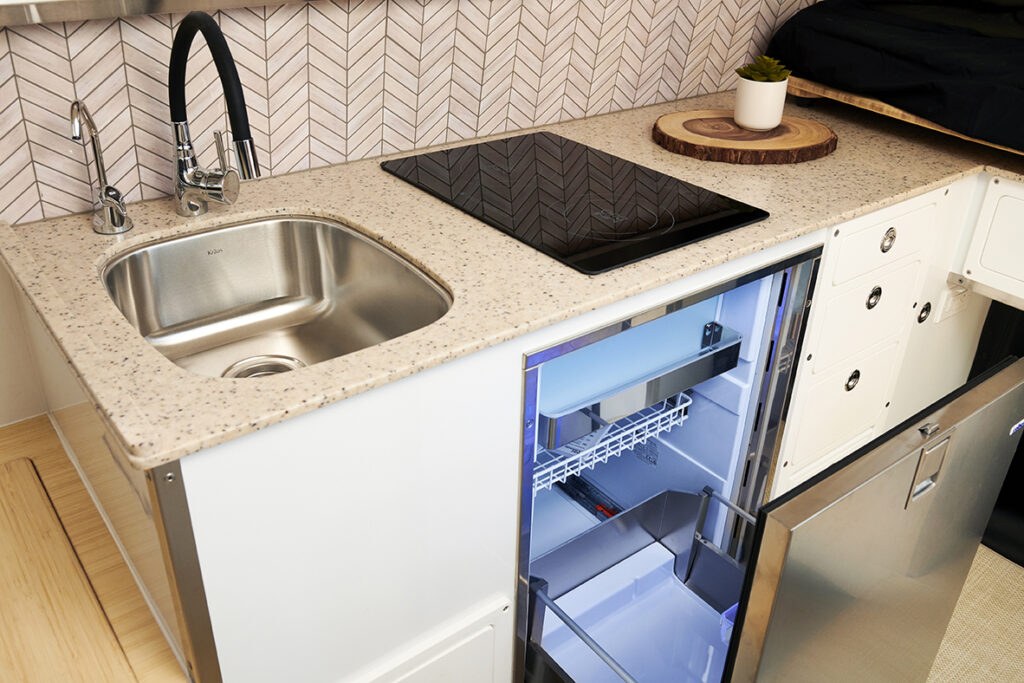 kitchen galley area of camper with refrigerator