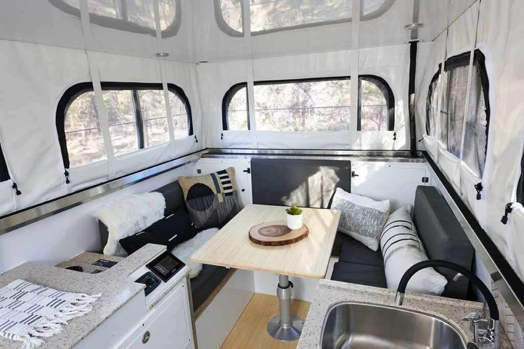 lounge area with table and seats set up in camper