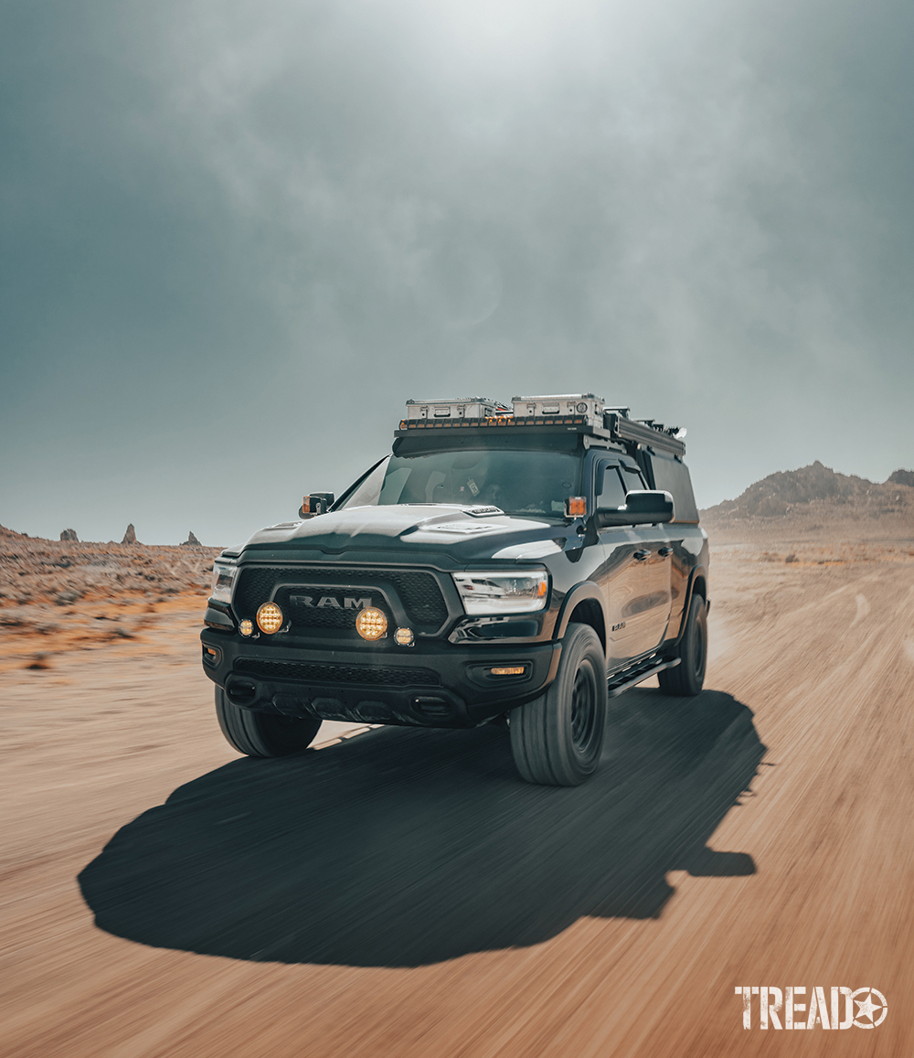 This adventure-ready truck can tackle trails on the dirt, sand, snow, and everything in between. It's driving quickly on dirt trails as the sun beats behind it.