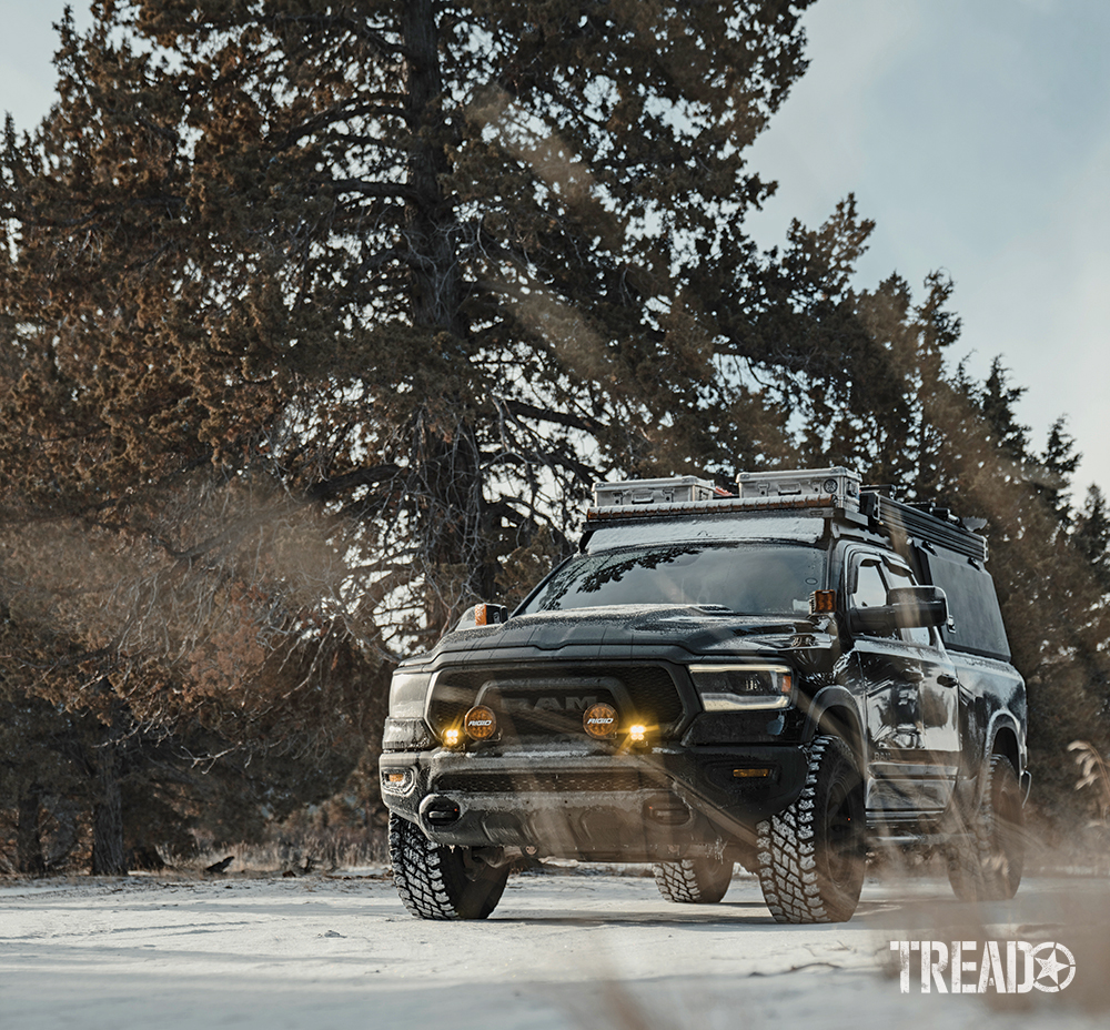 This capable RAM 1500 Rebel EcoDiesel Rebel 4x4 is plenty capable, even in the snow (with tall pine trees behind it). 