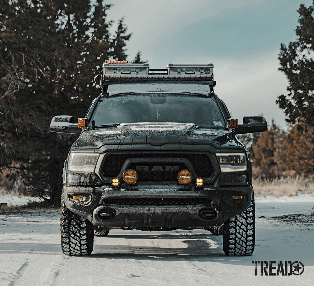 The RAM truck sits on a thin layer of snow and shows off its Rigid 6-inch 360 Series and 360 Series SAE ambers lights.