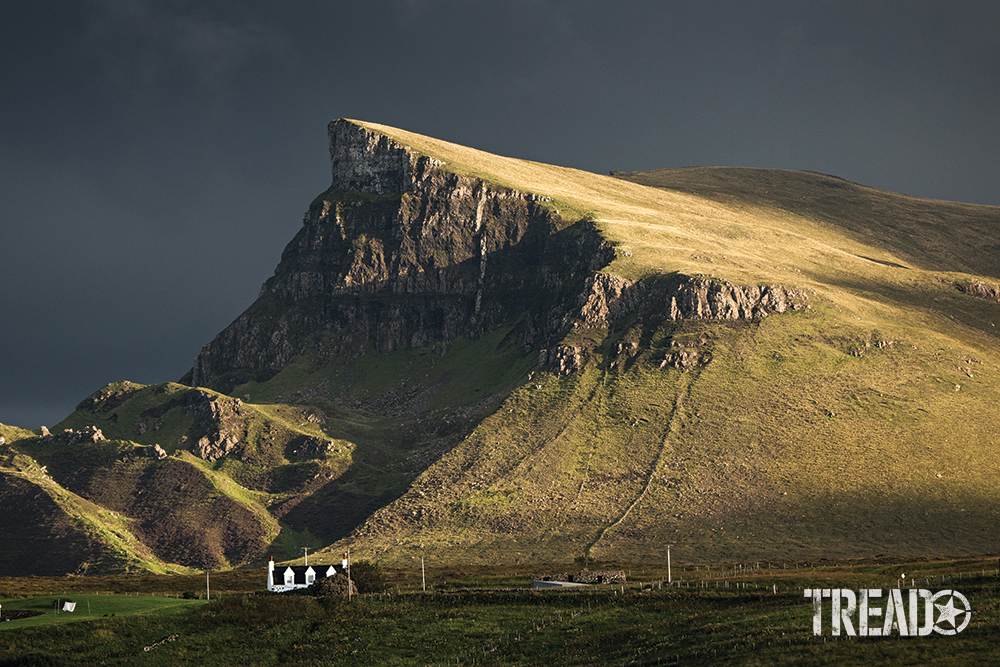 Scotland offers cliff-facing, lush hillsides, like this one that points to an angry gray sky.