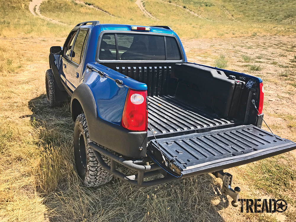 This Titan SideKick gasoline transfer tank is mounted in a blue and black Ford Sportrac Prerunner. 