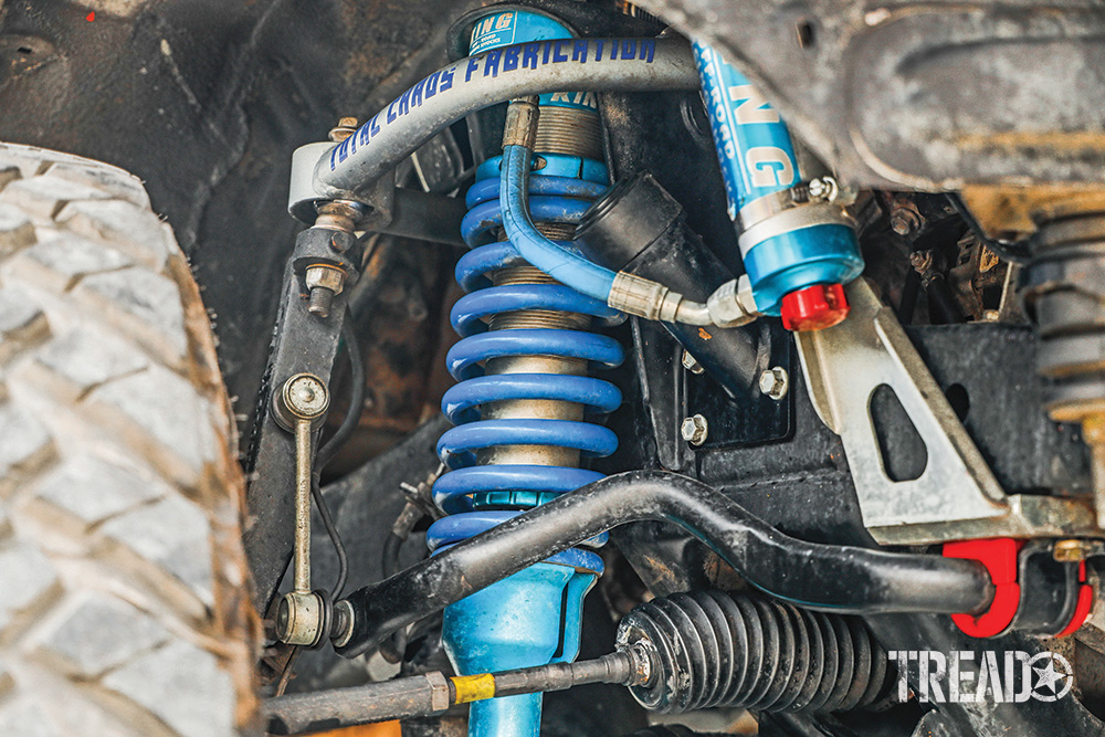 King Shocks 2.5 coilovers with reservoirs and Total Chaos UCAs are seen on an off-road Lexus GX 470.