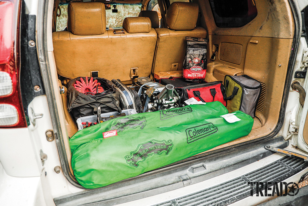 The rear cargo area reveals a medium-tan interior which is used for Brian’s air compressor, Pro Eagle, recovery gear, bright green camp chairs and more.