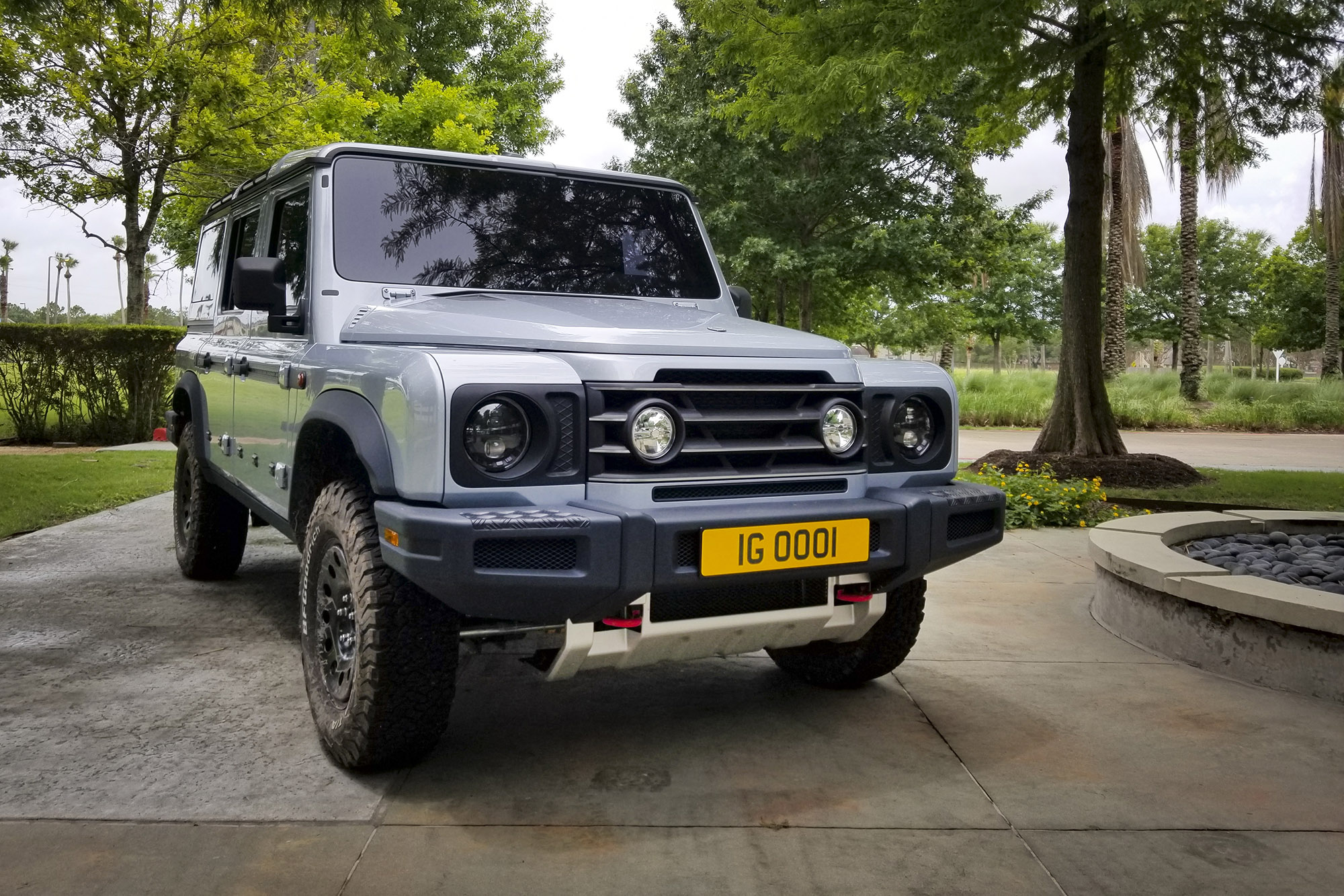 A silver 4-door INEOS Grenadier 4x4 parked on pavement