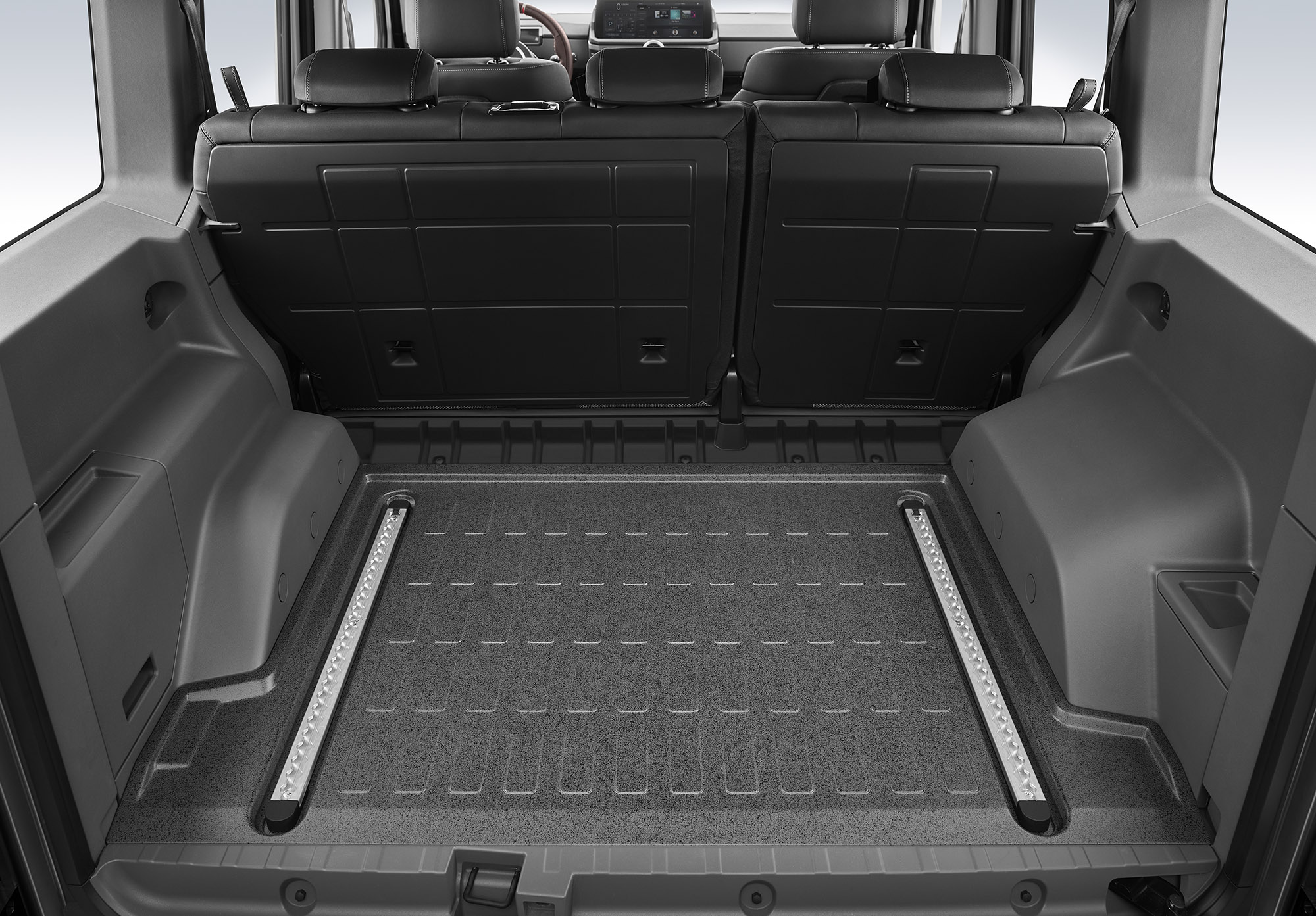 The black and gray rear cargo area includes secured storage areas and optional L-track railings to secure cargo. 