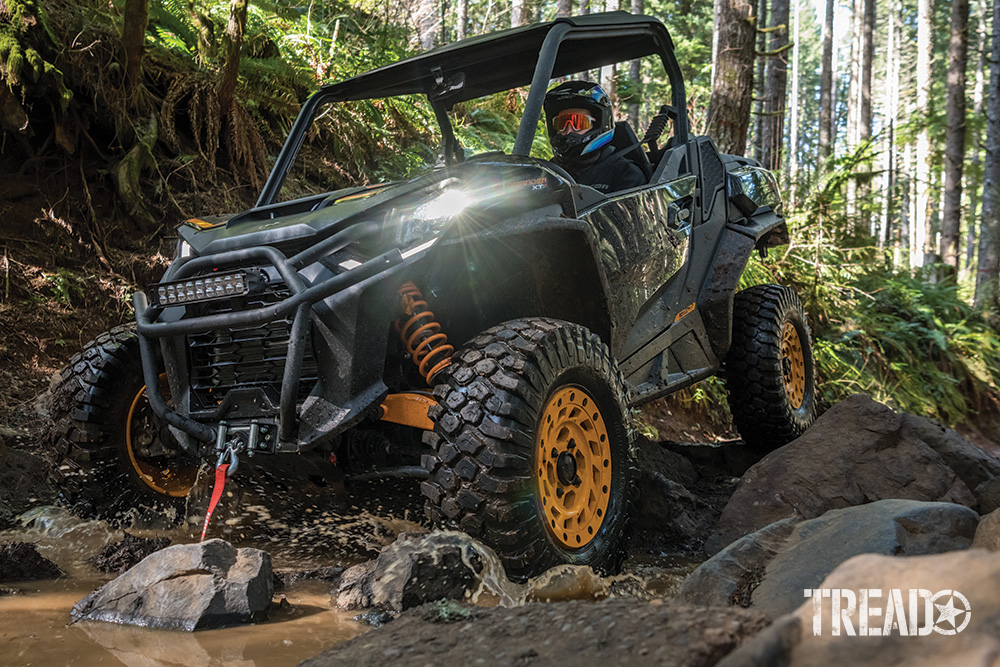 Can-Am Commander XT-P drives over water and rocks.