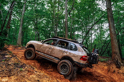 Porsche Cayenne drives in Uwharrie National Forest.