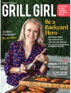 Woman holds basting brush next to grill.