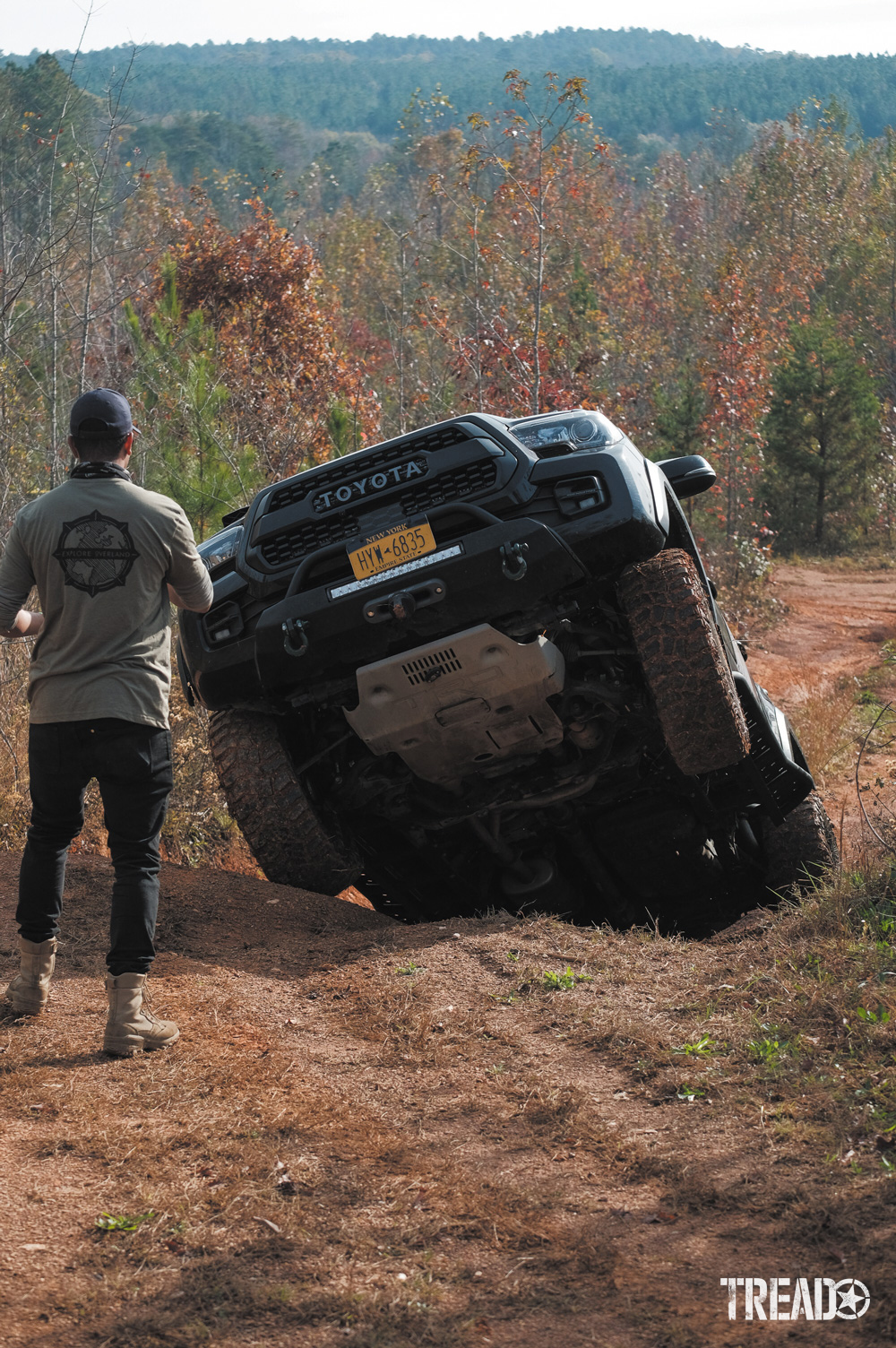 Raised front end of Toyota showing skid plate.