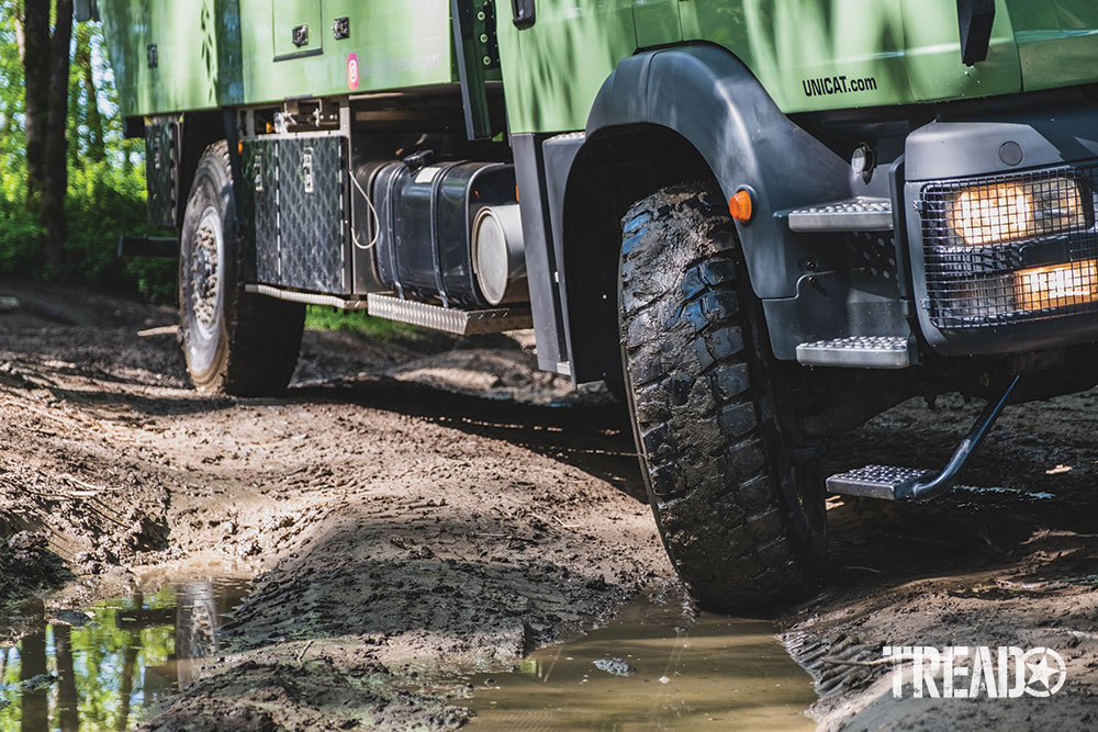 Tires turn on the mint green MAN expedition truck.