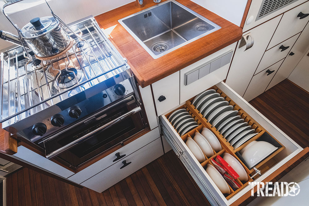 The interior of the mint green MAN expedition truck has a full functioning kitchen with locking drawers and oven and cooktop.