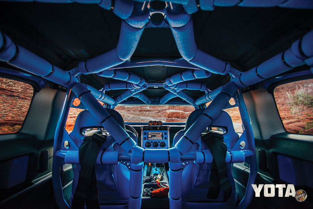 The rollcage inside the blue FJ Cruiser is covered in blue pool noodles.