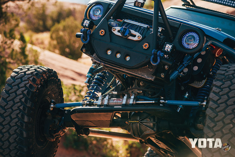 The front end of a blue FJ Cruiser flexes, showing off suspension.