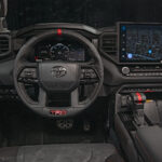 Interior shot of steering wheel and dash of 2022 Toyota Tundra TRD Pro in Solar Octane orange