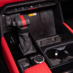 Gear shifter and red interior of red interior of 2022 Toyota Tundra TRD Pro in Super White