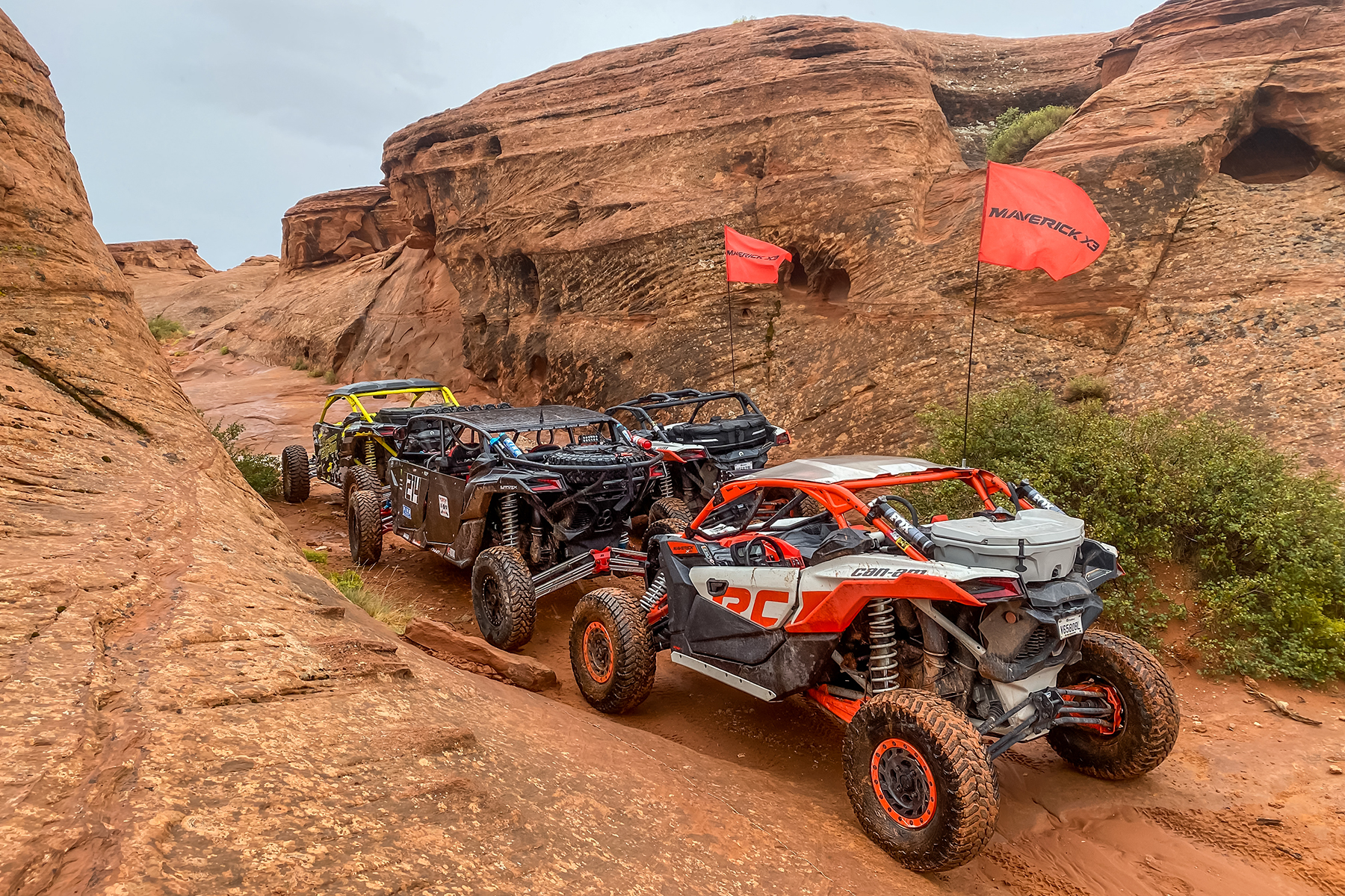 Can-Ams drives up steep slippery rocks at International Off Road Day in Sand Hollow State Park at Trail Hero.