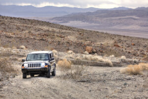 An off road vehicle in a desert landscape in Death Valley National Park. 