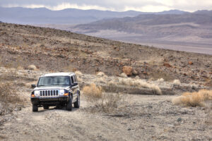 An off road vehicle in a desert landscape in Death Valley National Park. 