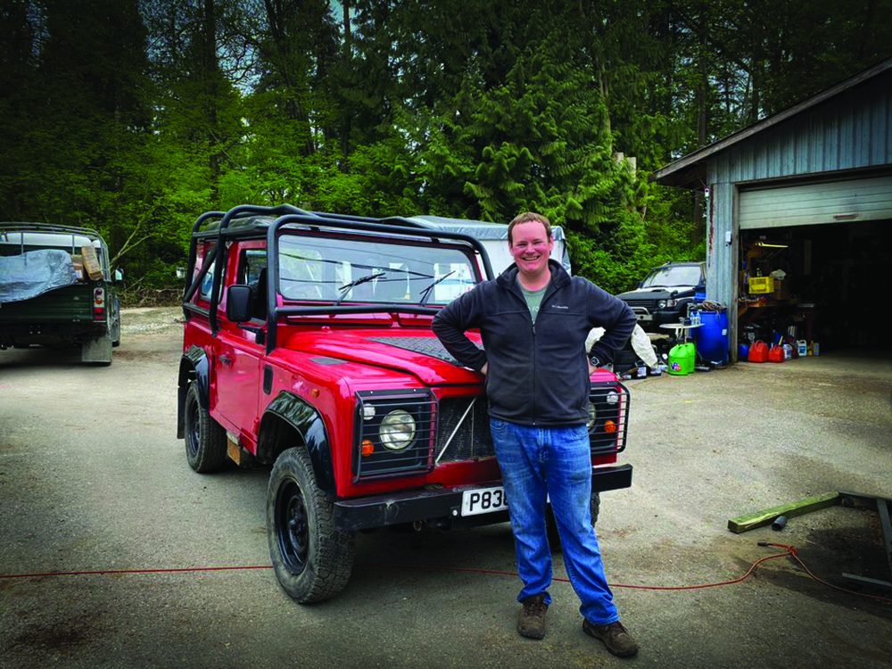 McKay and his vehicle pose in a driveway.