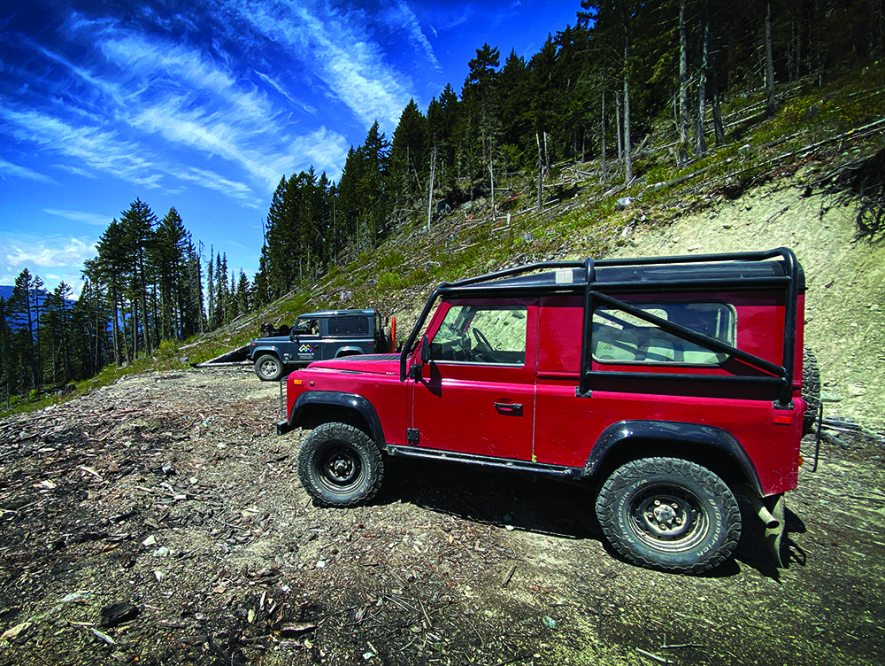 McKay's red Land Rover prepares to tackle Canadian mountain terrain.