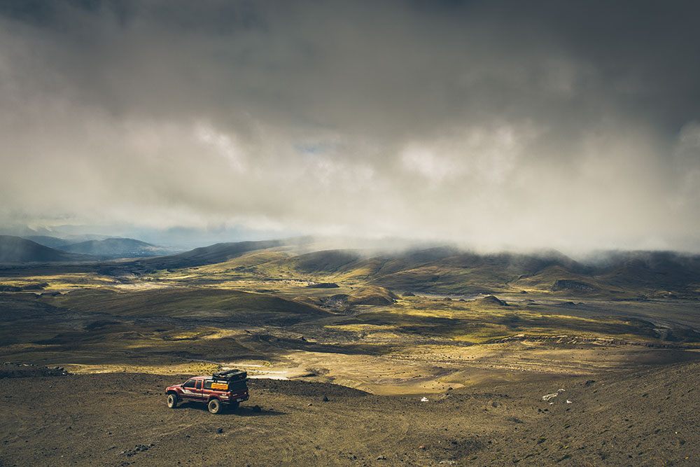 A wide shot of Little Red parked on the edge of the wilderness.