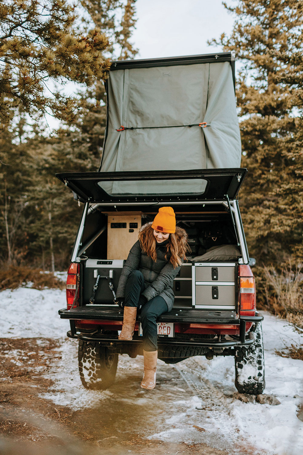 Ashley balances on the truck's tailgate.