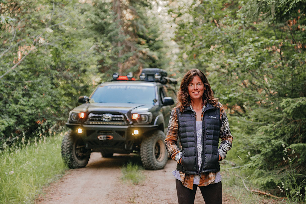 Lizzy smiles for the camera with the Tacoma in the background.