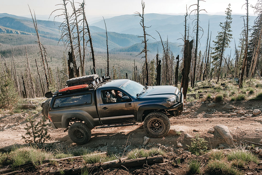 Lizzy surges uphill in her regular cab Tacoma.