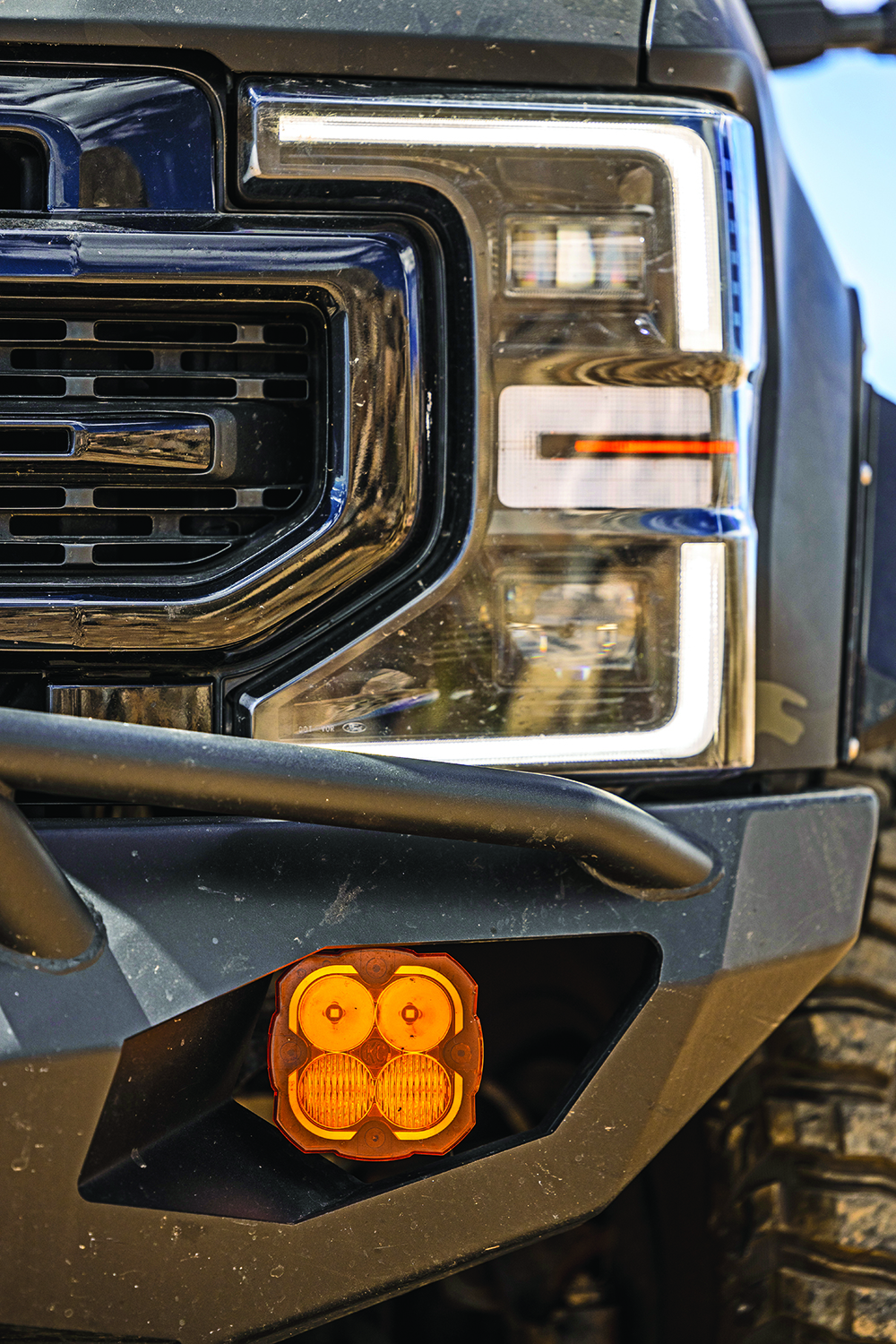 A closeup of the F250's headlights and KC HiLites fog lights.