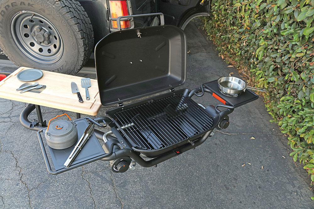 The Ultimate Hitchfire Grill setup with cutting board, side burner and side table to take anywhere because it attaches to the hitch on a SUV or truck.