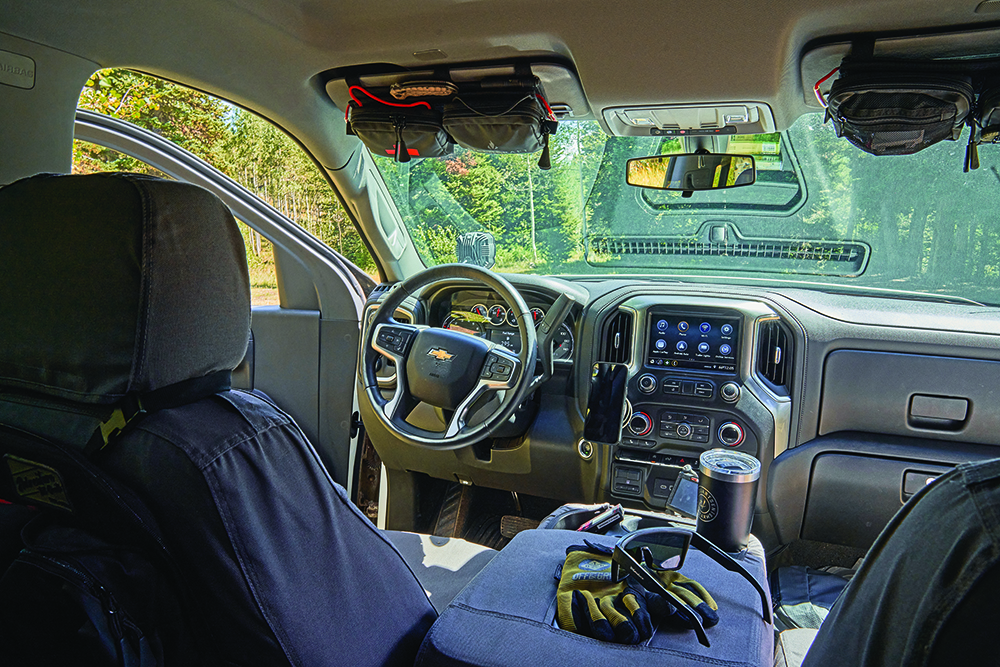 Extra storage pouches by Fieldcraft Survival within arm’s reach on the visor of Yeti Norvell's Silverado