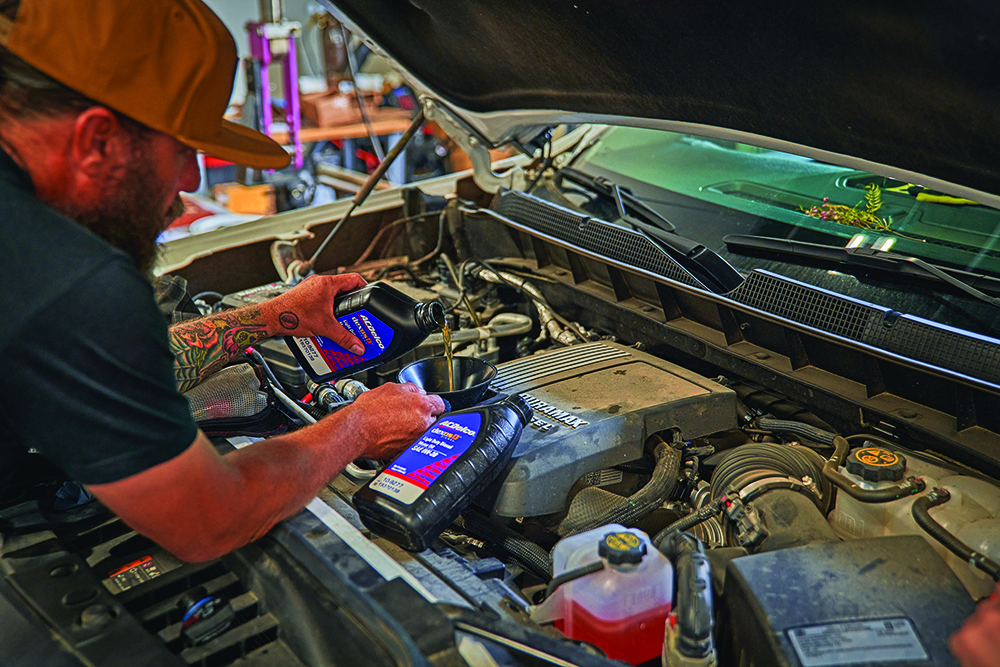 Yeti Norvell puts oil in the DeeZee Silverado that also serves as his daily work truck