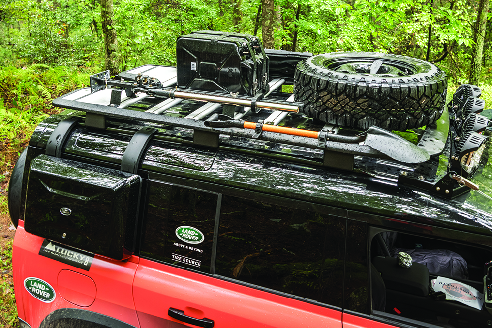 The Land Rover roof rack loaded with a spare tire, shovel, Hi-Lift, two jerry cans and Tred Pros.