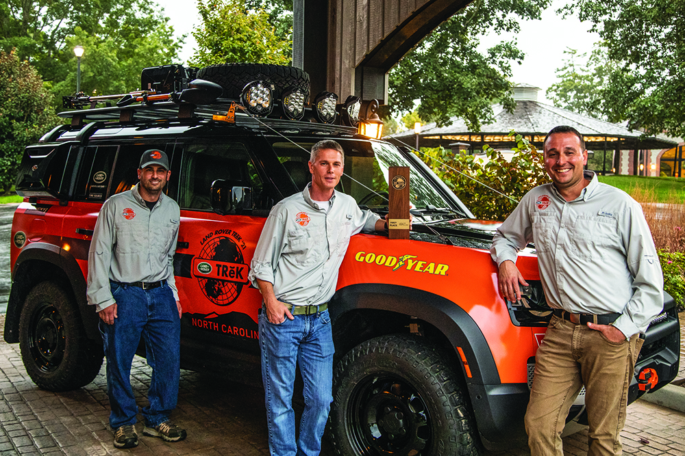 Overall TReK 2021 Winners, Land Rover Rochester, stand with their Defender and trophy.