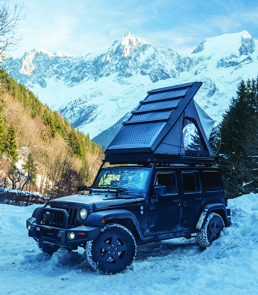 A Jeep is camped with rooftop tent in the French Alps