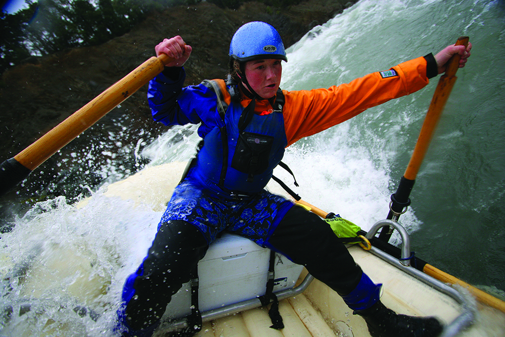 Rafter steers in white water
