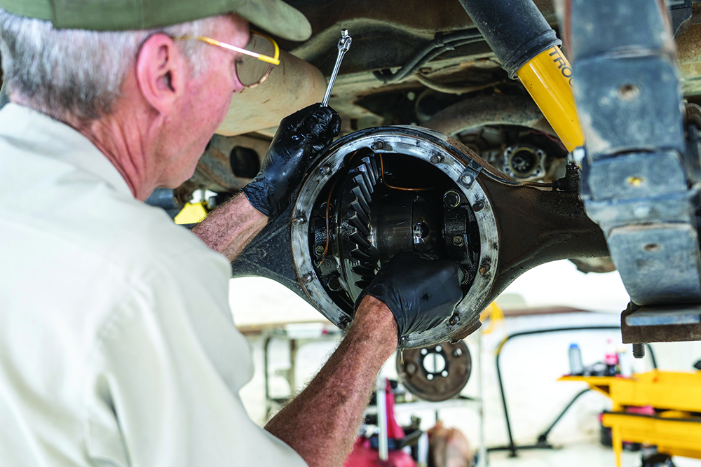 Mechanic installing the new ring and pinion gears under the FJ40..