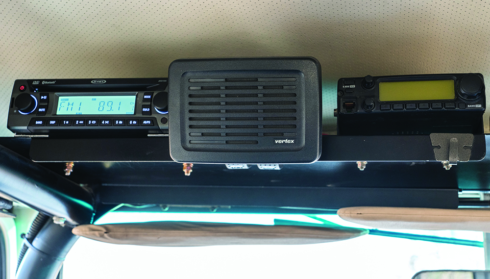 Overhead rack holds stereo plus a two-meter radio with an external speaker.