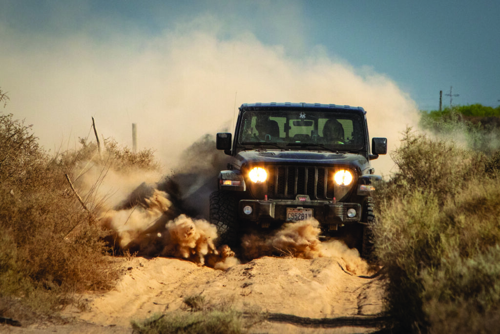 A competitor pushes through silt in their Jeep.