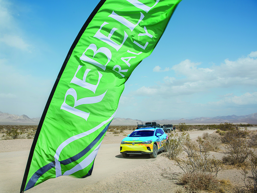 The colorful SUV waits in front of a green flag to begin the rally.