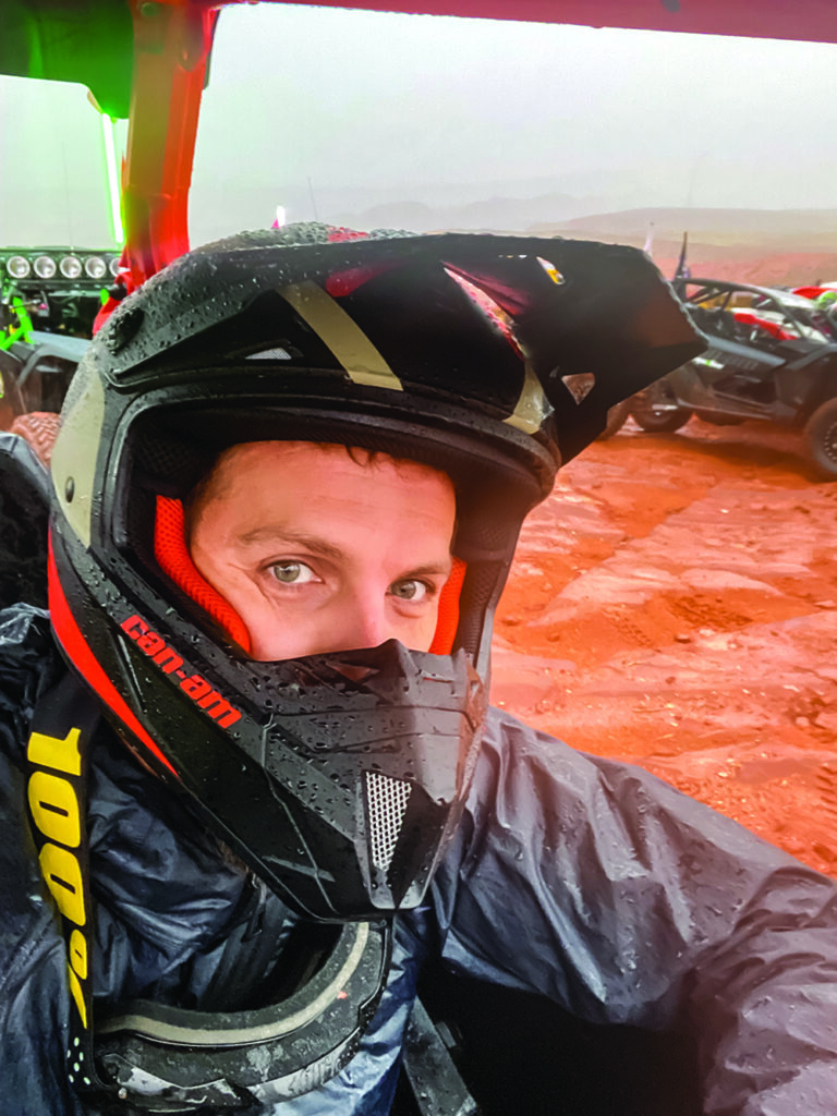 A selfie of the author sporting an off-roading helmet and rain gear.