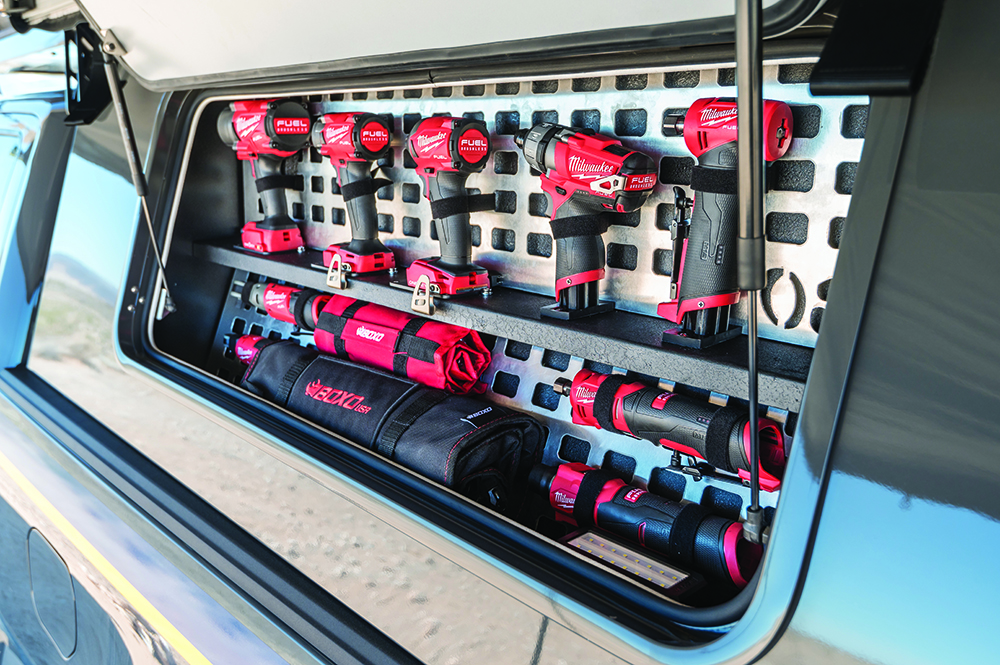 Milwaukee power tools stored in a custom mounting box.