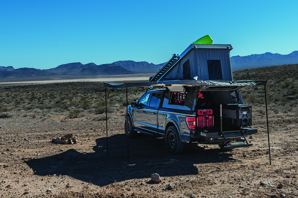 The F-150's full camping setup includes an awning and bed pop-up.