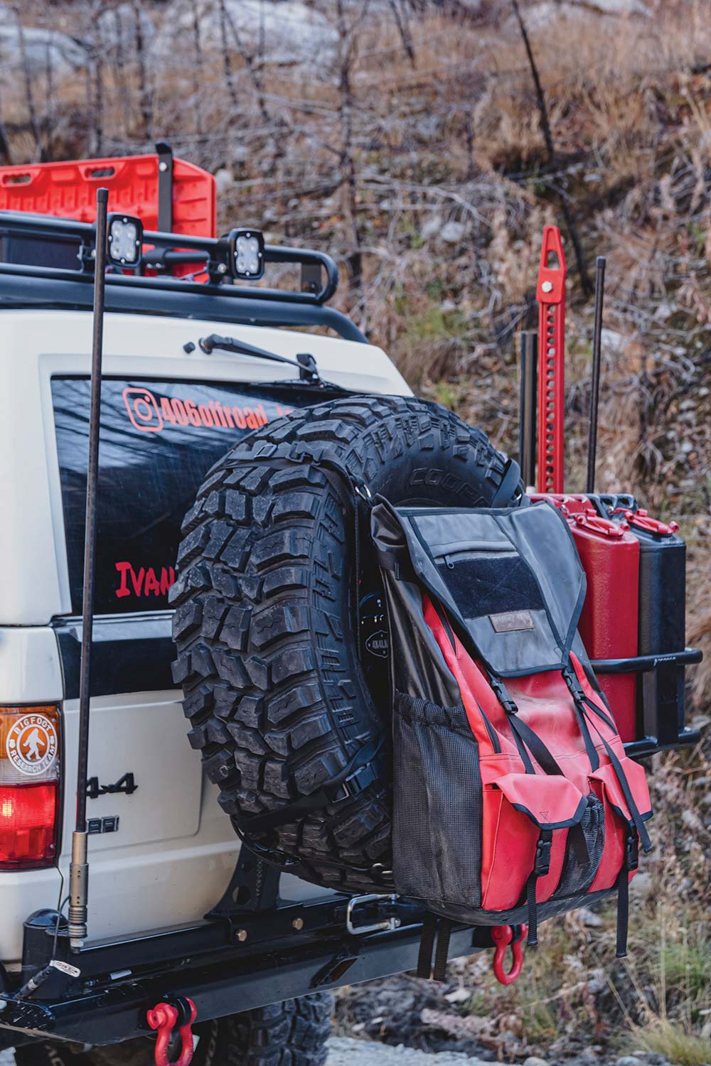 The 4x4Labs dual swingout rear bumper carries the spare tire, bag, two jerry cans, and a jack.