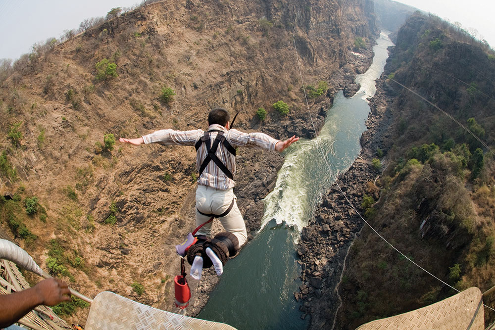 A wide angle lens made this outdoor photograph of a person jumping off a bridge look rounded.