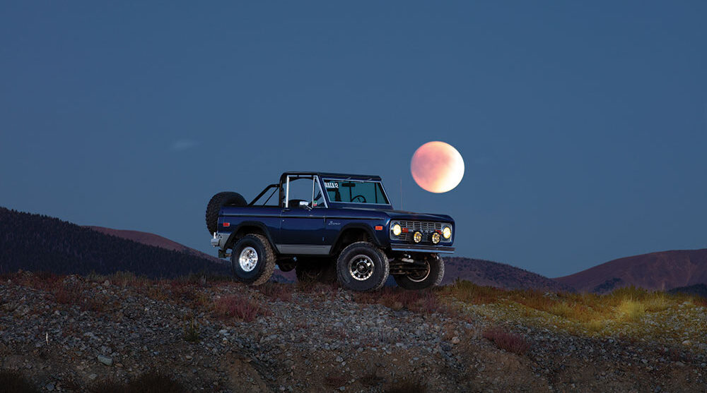 Outdoor photography of a car under the moon.