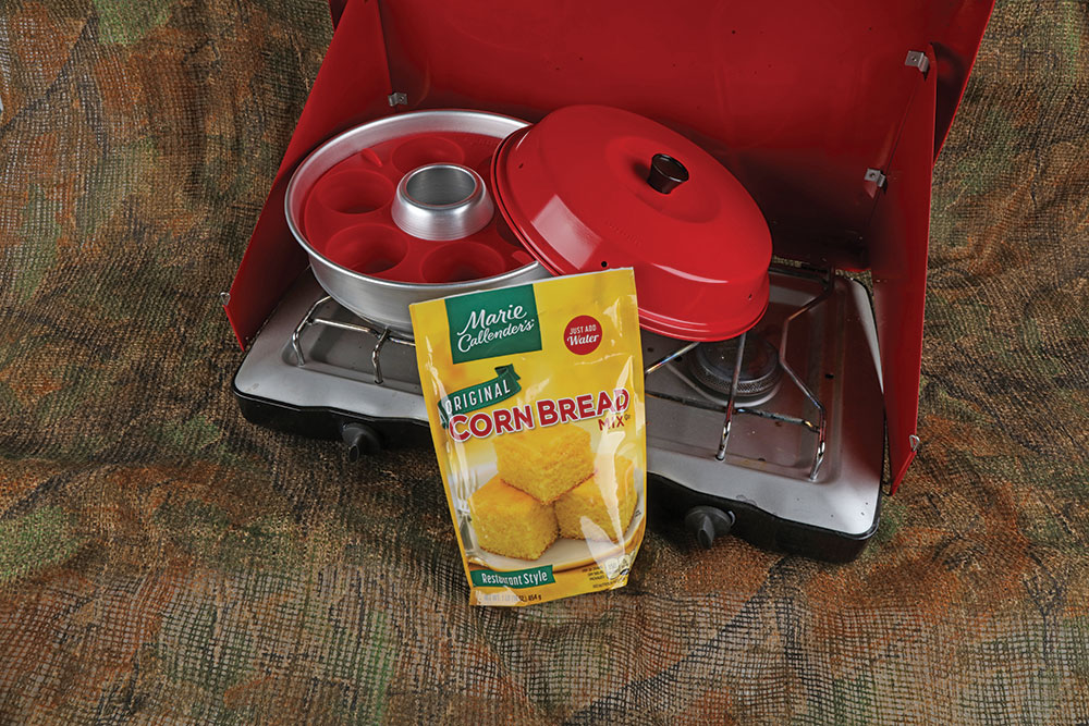 Red Omnia stovetop oven and yellow cornbread packet.
